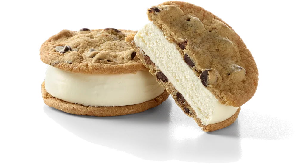 Cross-section of a Chessters sandwich showing dense vanilla custard between two chocolate chip cookies